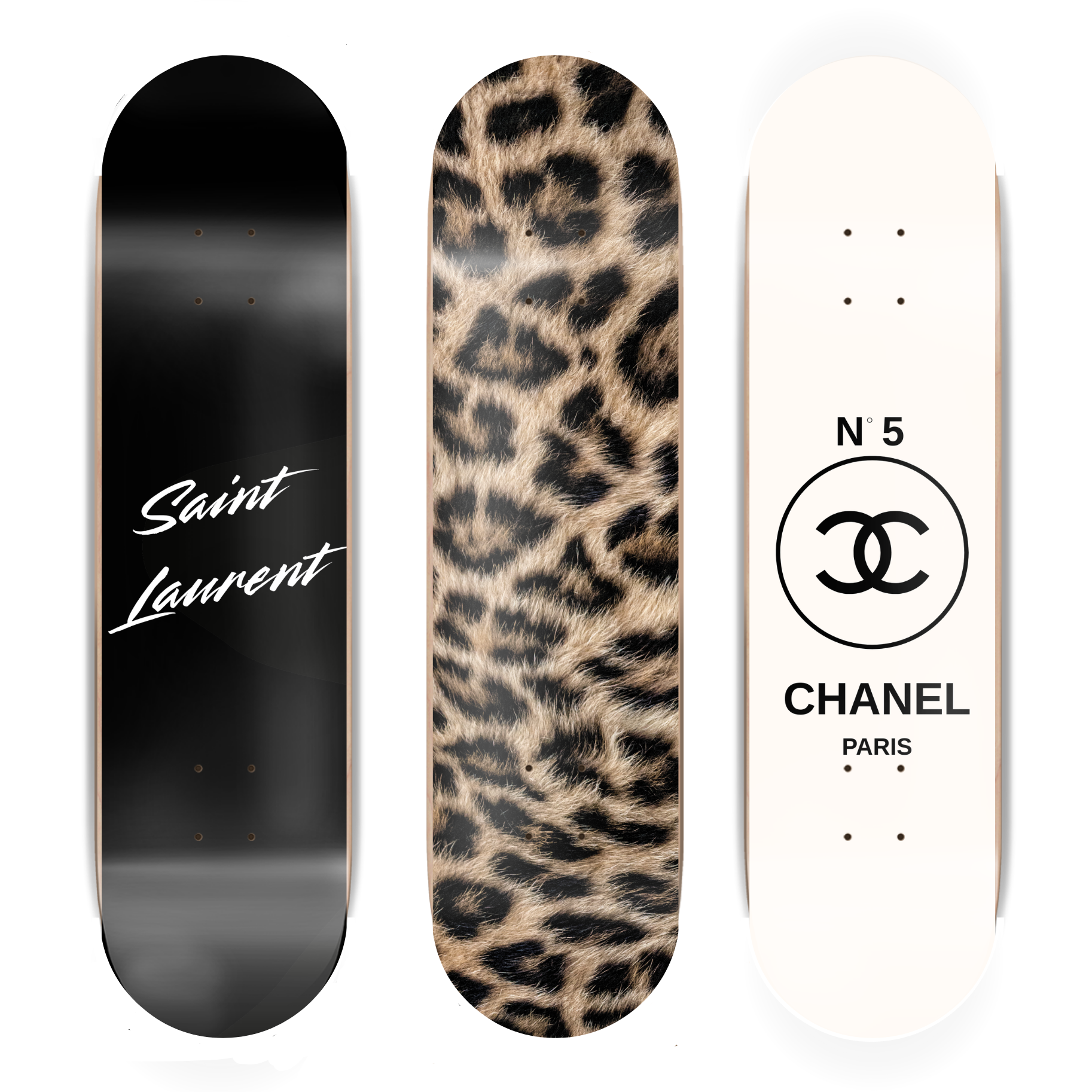 Three skateboard decks with different designs and brand logos on a white background.