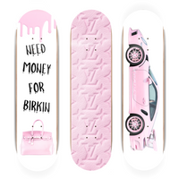 Three pink skateboard decks with different designs on a white background